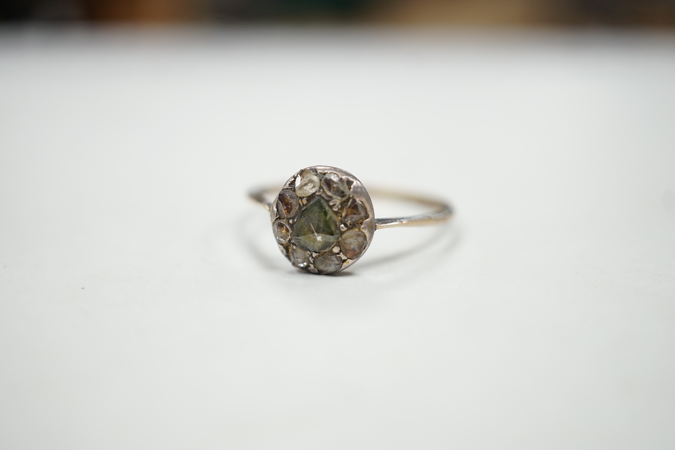 An antique yellow and white metal set rose cut diamond cluster ring, size S/T, gross weight 2.2 grams.